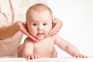 masseur massaging baby girl